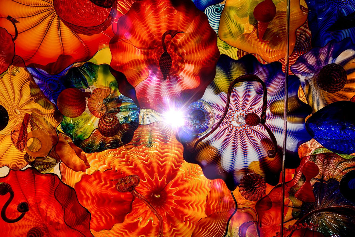 Colorful blown-glass ceiling with light bursting through the middle